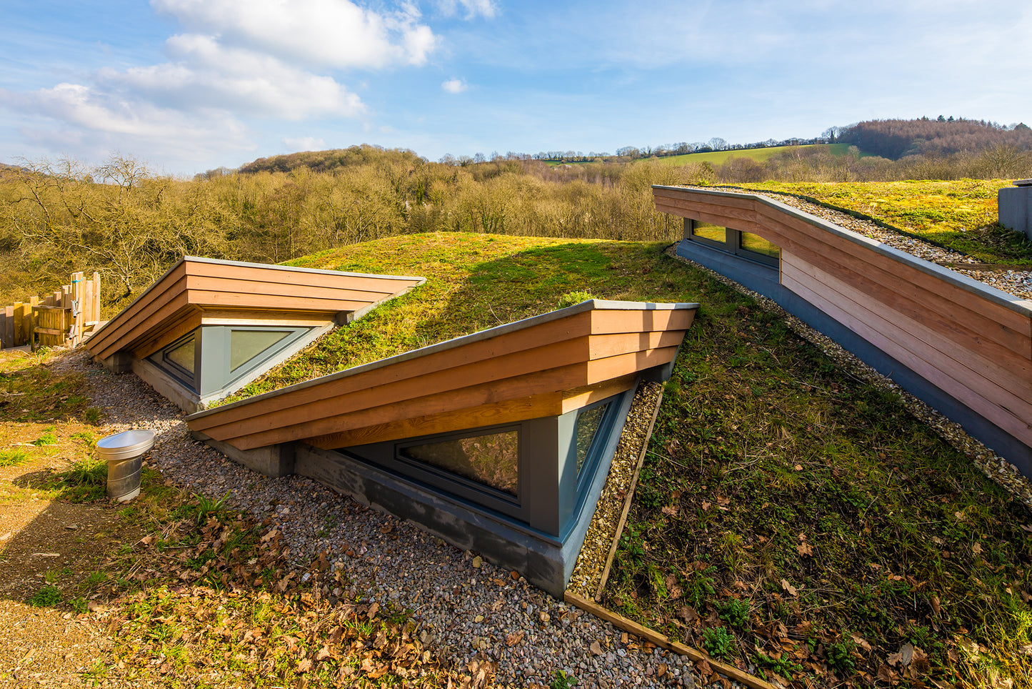 External view of a triple-glazed, aluminum-clad angled window in the roof of a stunning passive house.