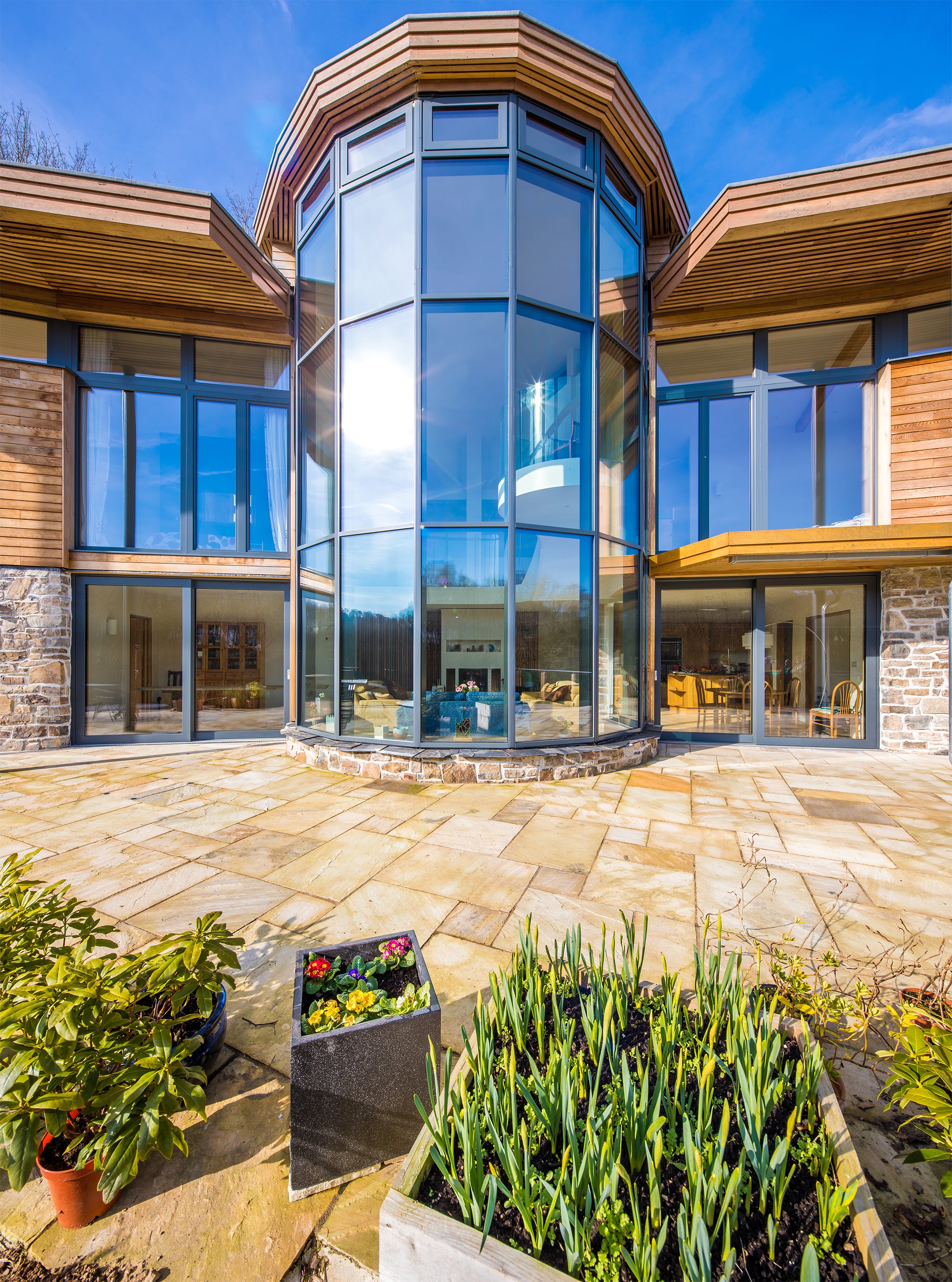 External view of a triple-glazed, aluminum-clad long window in a stunning passive house.