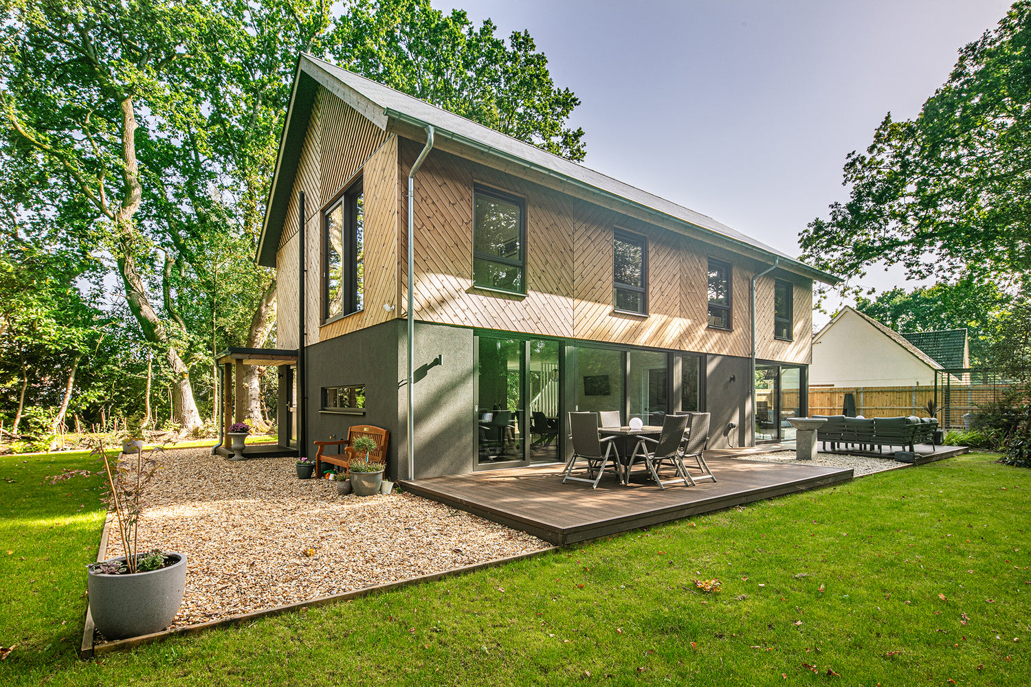 Patio view of a triple-glazed sliding door in a funky Dorset new build.