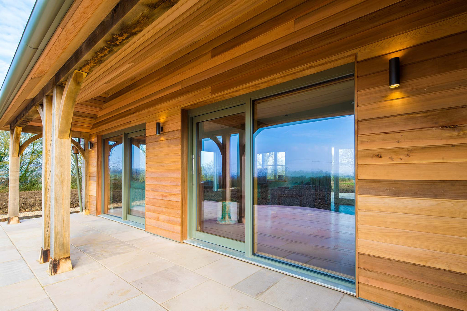 Wooden exterior of a modern building with large double-glazed glass windows