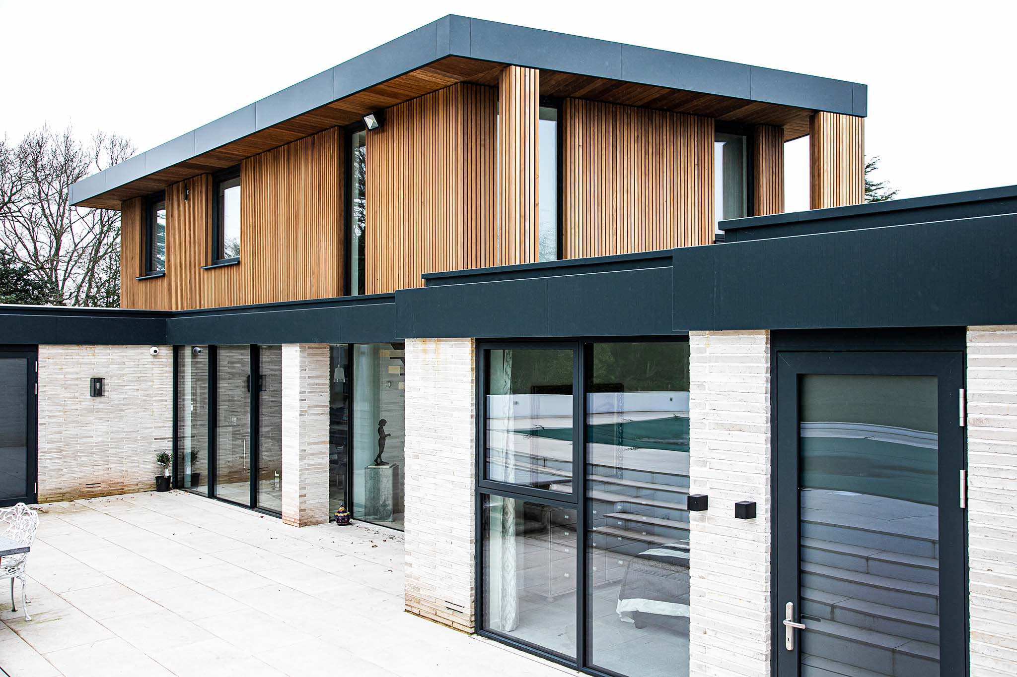 Modern triple-glazed house with wooden and brick exterior