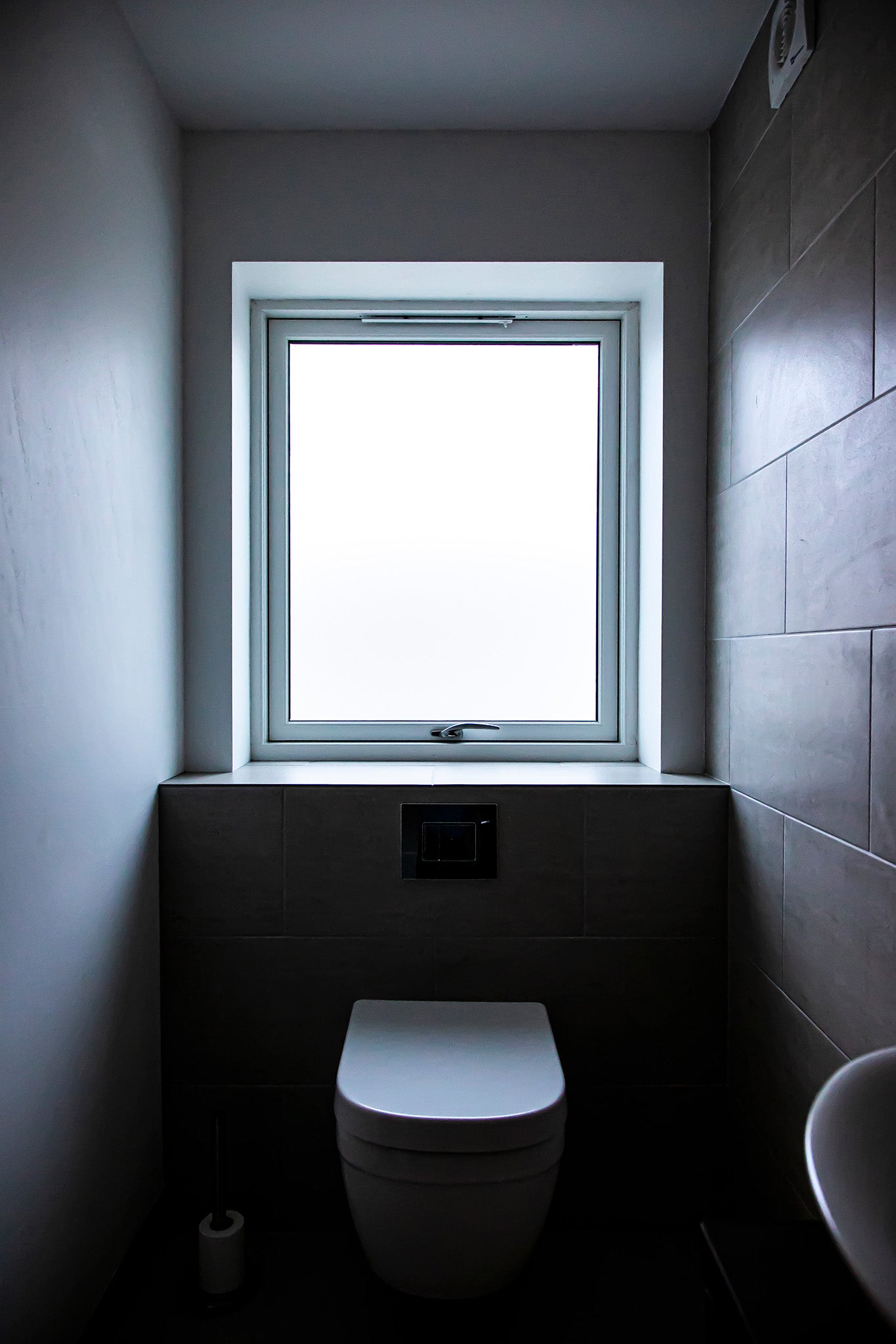 Modern bathroom with a toilet and a double-glazed window letting in light