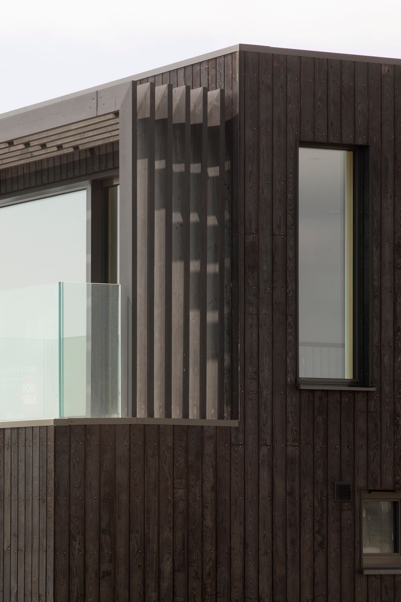 Wooden exterior of a building with triple-glazed glass panels