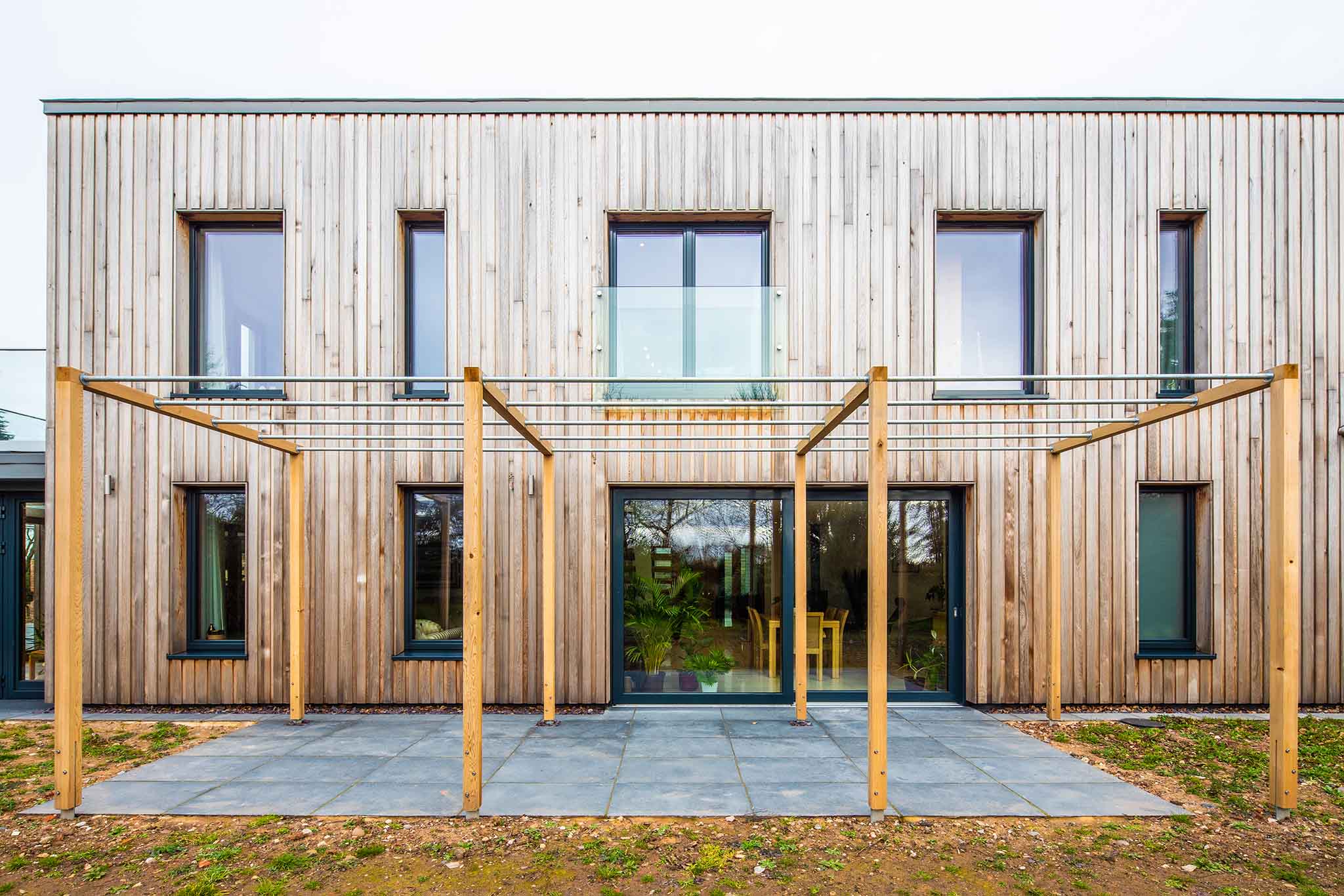 Modern building with wooden facade and triple-glazed glass doors