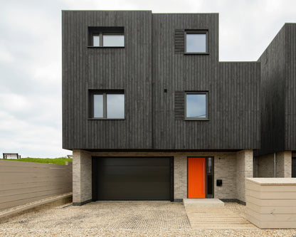 Rear elevation view of a triple-glazed panel door in coastal seaside property.