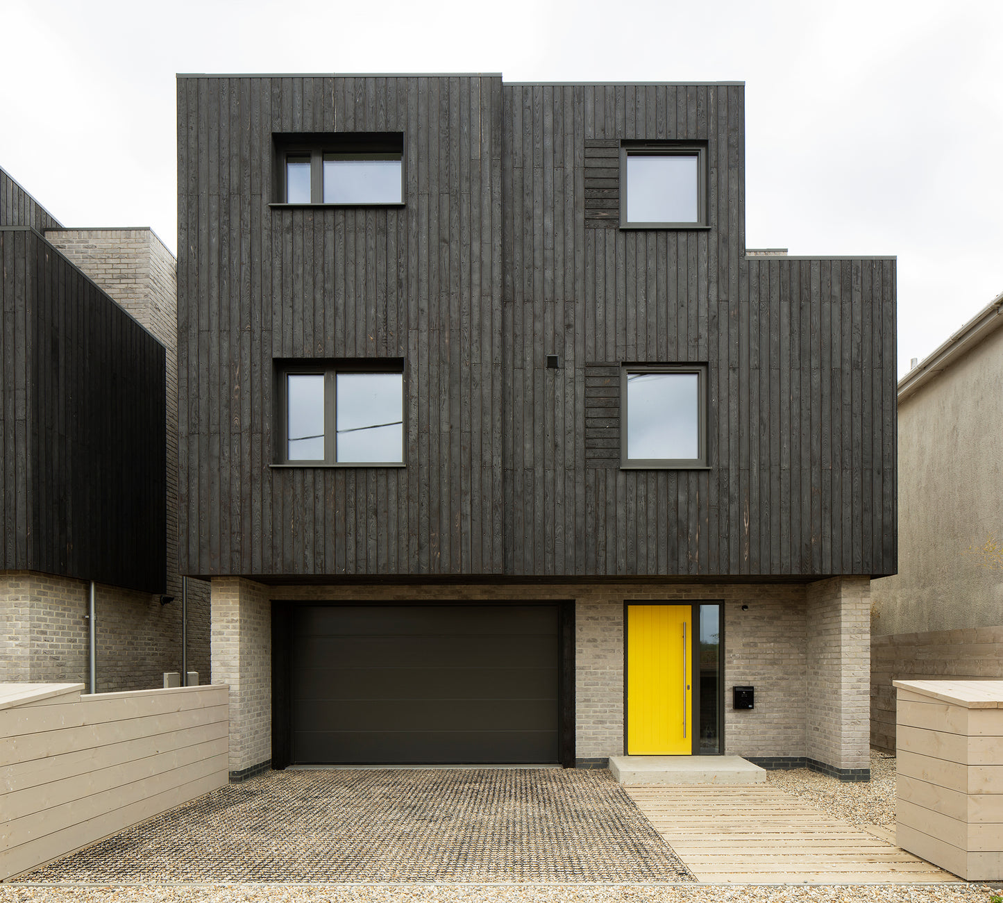 Rear elevation view of triple-glazed features in a coastal seaside property.