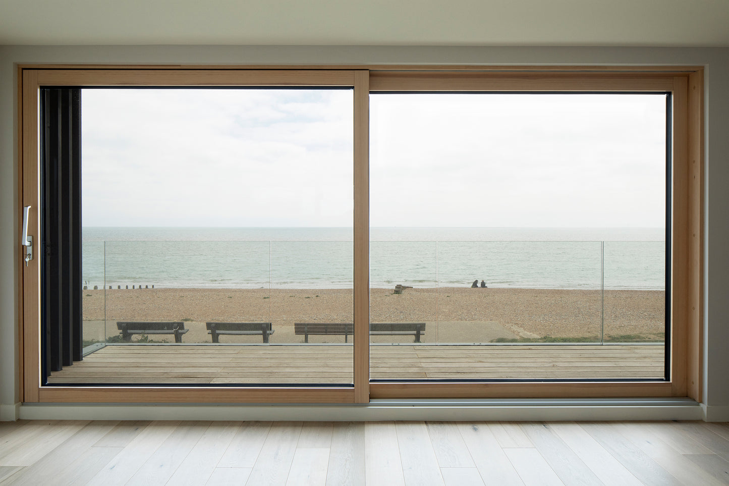 Interior view of a triple-glazed sliding door in a coastal seaside property.