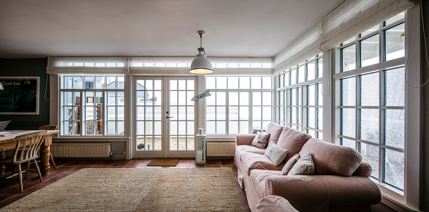 Internal view of a double-glazed, aluminum-clad composite window and framed door in a seafront renovation.