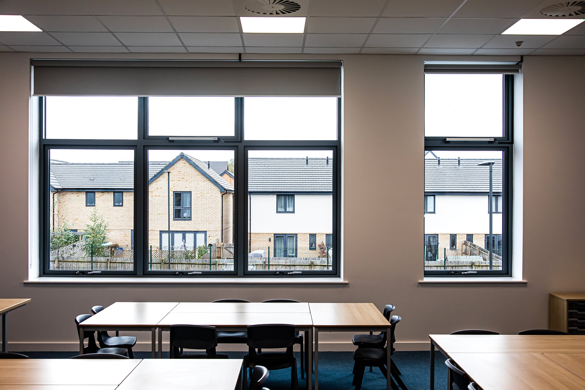Internal view of a triple-glazed, aluminum-clad outward-opening window in a passive house school.