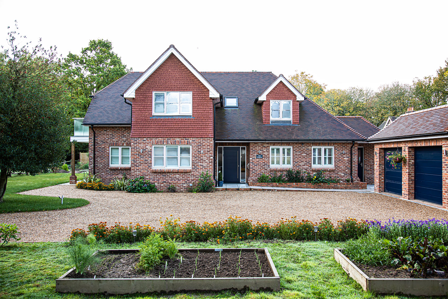 External view of a triple-glazed entrance panel door in a traditional new build.