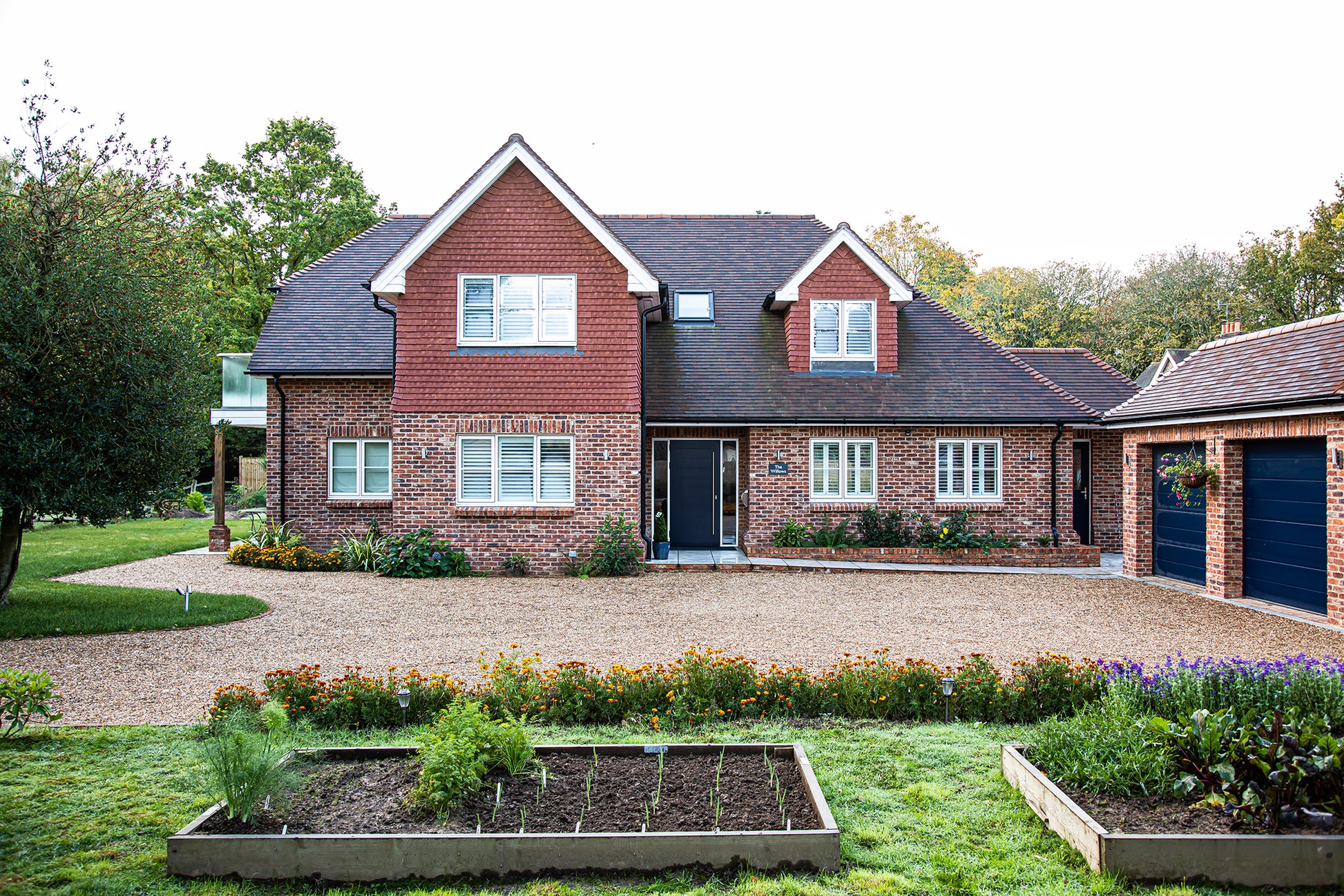 External view of a triple-glazed entrance panel door in a traditional new build.