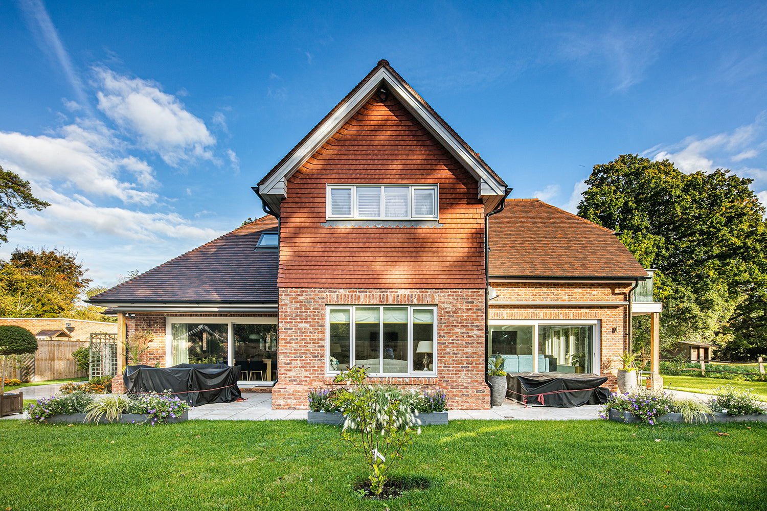Rear elevation view of triple-glazed features in a traditional new build.