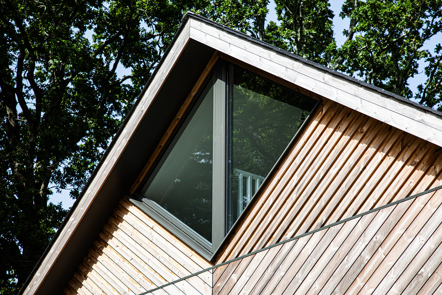 External view of a triple-glazed, aluminum-clad angled window in a funky Dorset new build.