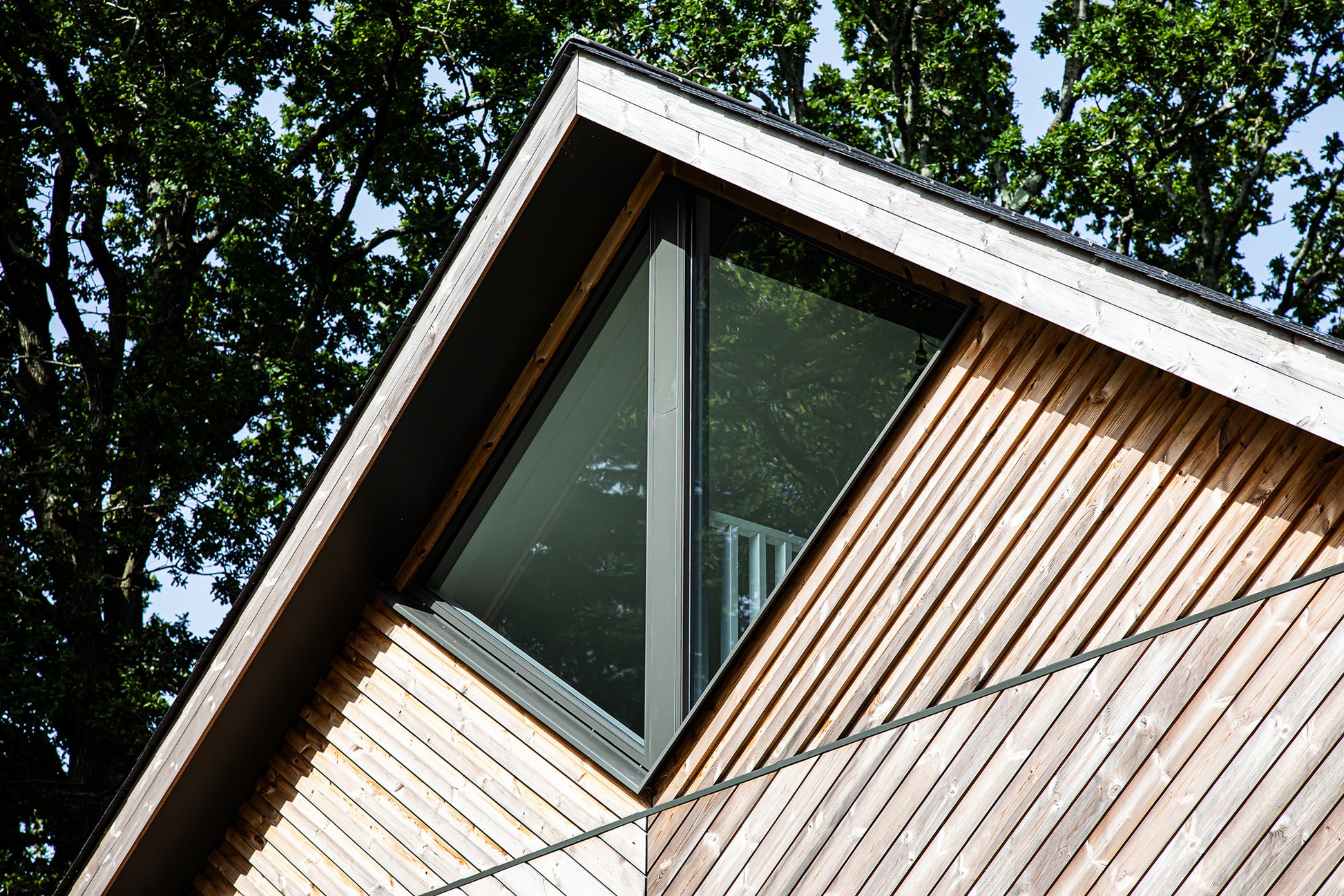 External view of a triple-glazed, aluminum-clad angled window in a funky Dorset new build.
