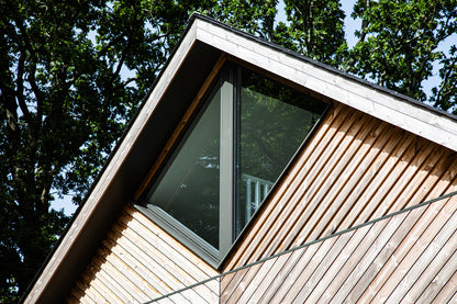 External view of a triple-glazed, aluminum-clad angled window in a funky Dorset new build.