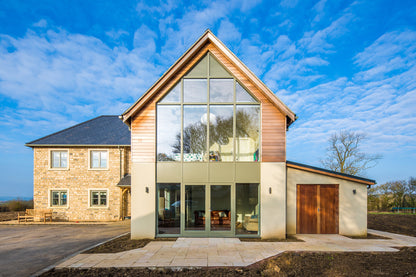 External view of a double-glazed, aluminum-clad framed door in a turnkey new build.