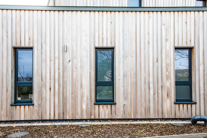 External view of a triple-glazed, aluminum-clad window in a rural passive house.