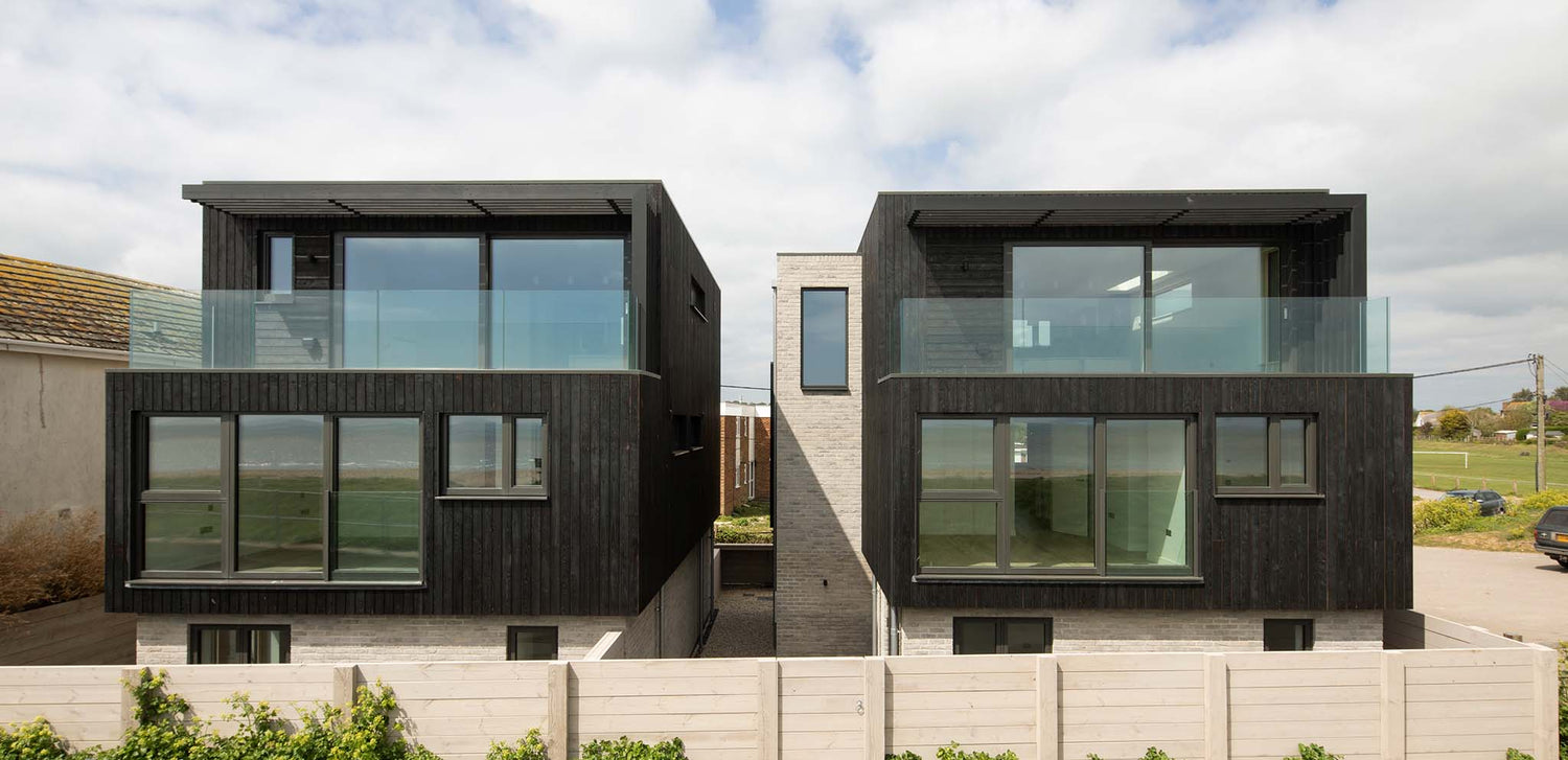 Modern coastal home with contemporary anthracite aluminium-clad timber windows on a clear day