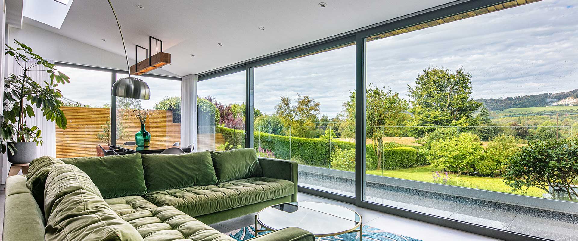 Image from an internal angle of a large, alu-clad sliding door in a modern style lounge