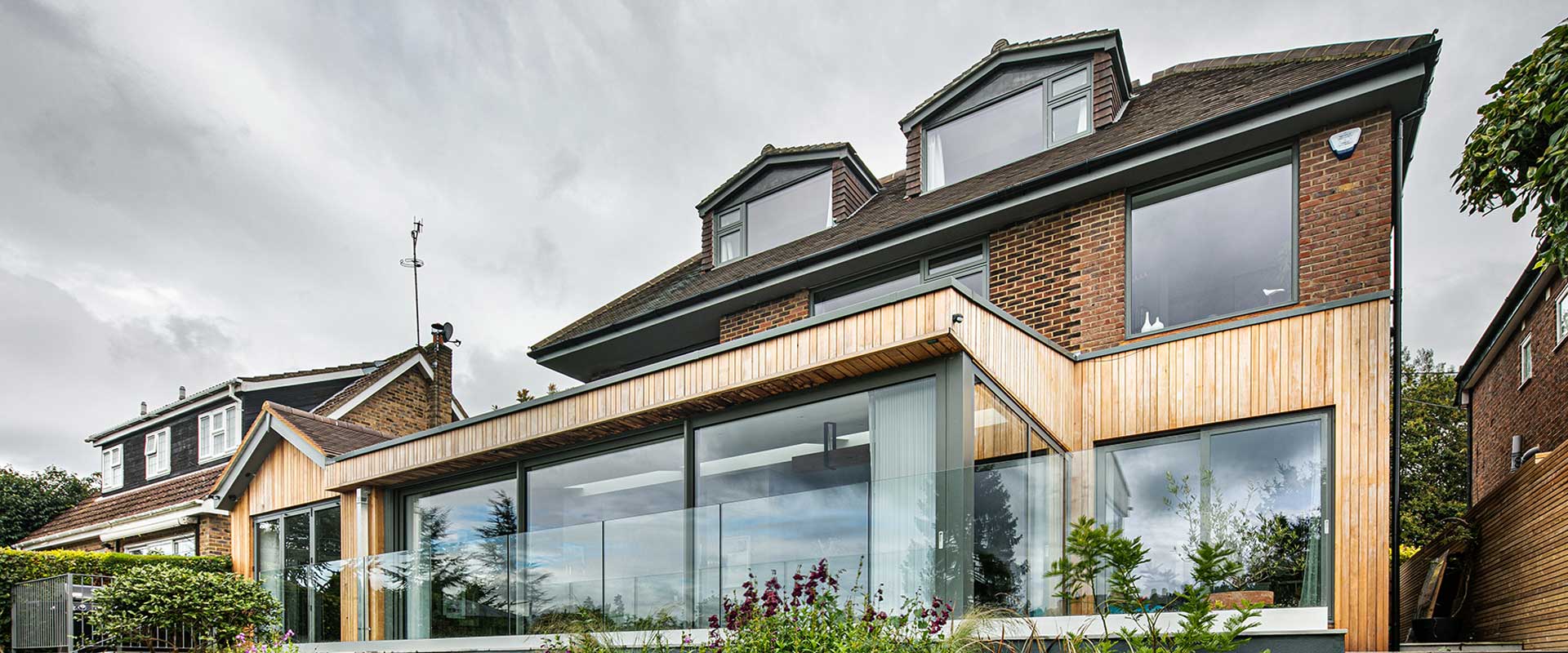 An image of a large extension on the rear of a family home with impressive alu-clad sliding doors