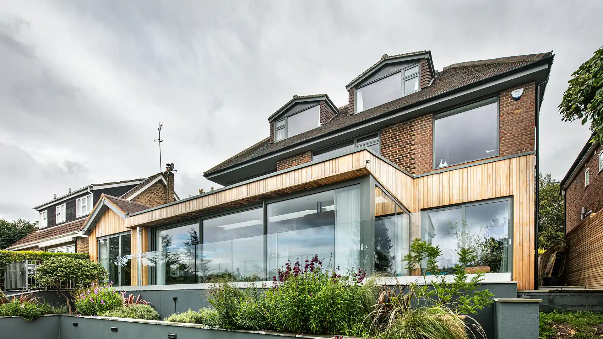 An image of a large extension on the rear of a family home with impressive alu-clad sliding doors