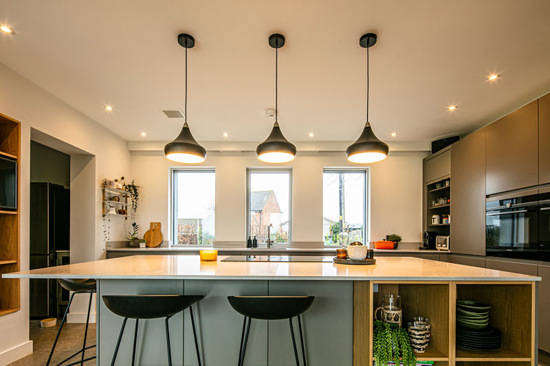 Image of a kitchen island facing three triple-glazed windows